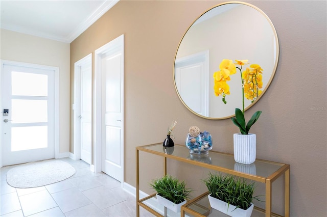 entryway with light tile patterned floors and crown molding