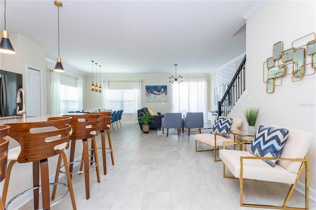 dining room with a notable chandelier and crown molding