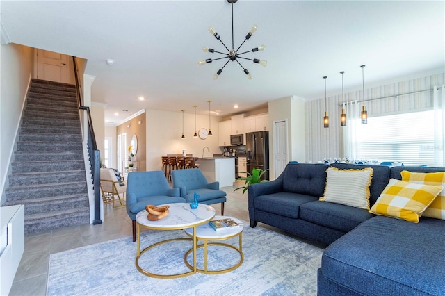 living room featuring light tile patterned flooring, crown molding, sink, and an inviting chandelier