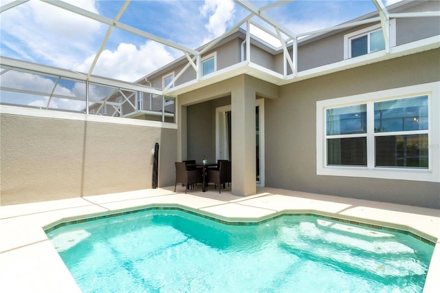 view of swimming pool with a lanai and a patio area