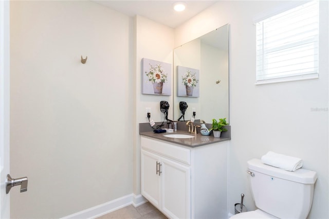 bathroom featuring tile patterned floors, vanity, and toilet