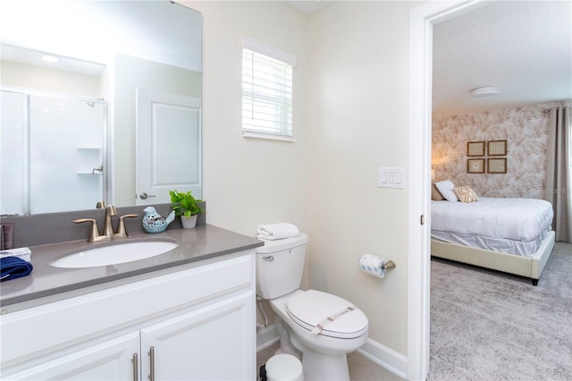 bathroom featuring toilet, vanity, and walk in shower