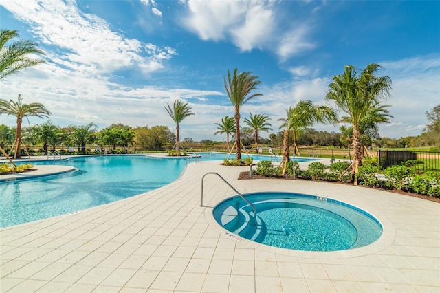 view of swimming pool featuring a patio area and a community hot tub