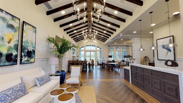 living room with dark parquet flooring, lofted ceiling with beams, and a chandelier