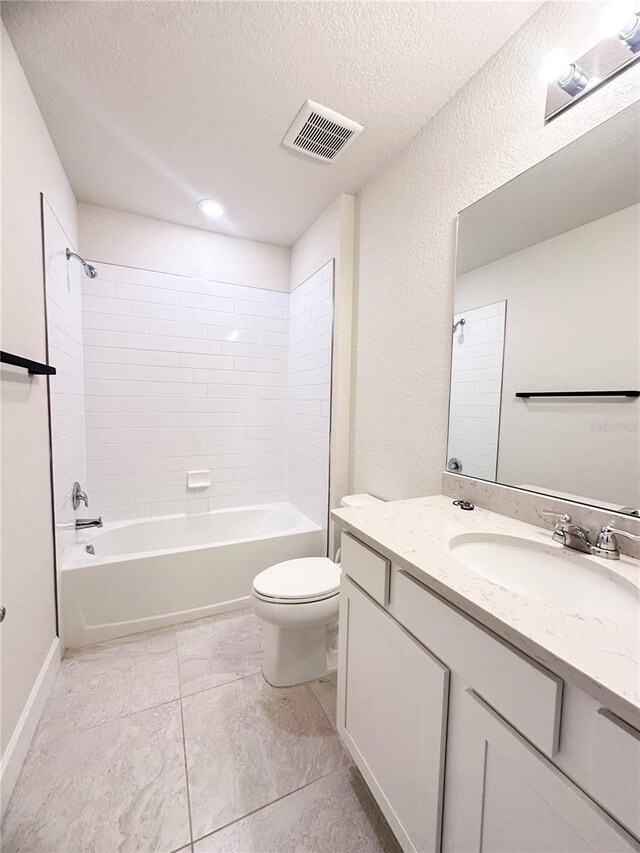 full bathroom with tiled shower / bath combo, toilet, a textured ceiling, and vanity