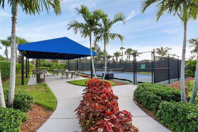 surrounding community featuring tennis court