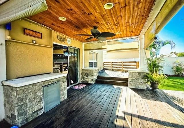 wooden deck featuring ceiling fan