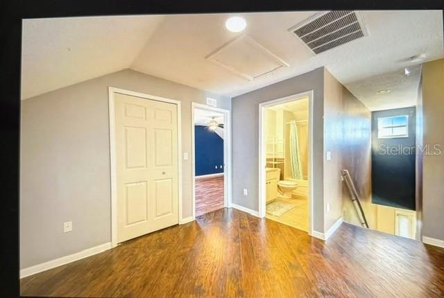 bonus room with vaulted ceiling and hardwood / wood-style flooring