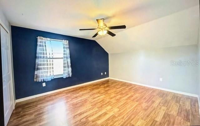 additional living space featuring hardwood / wood-style flooring, ceiling fan, and vaulted ceiling