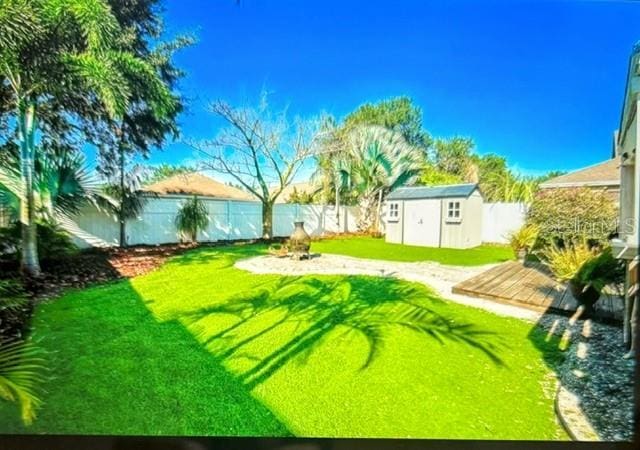 view of yard with a deck and a shed