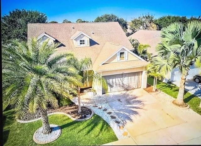 view of front of home with a front lawn and a garage