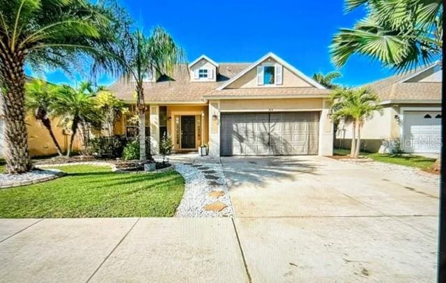 ranch-style home with a garage and a front lawn