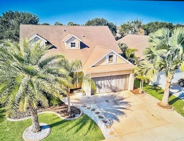 view of front of house with a front yard and a garage