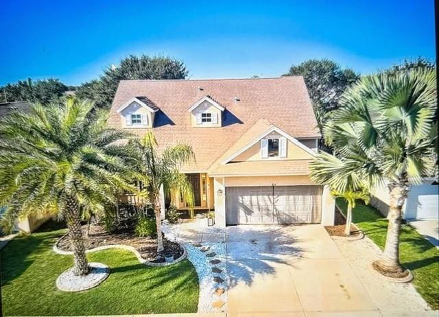 view of front of home featuring a front lawn and a garage