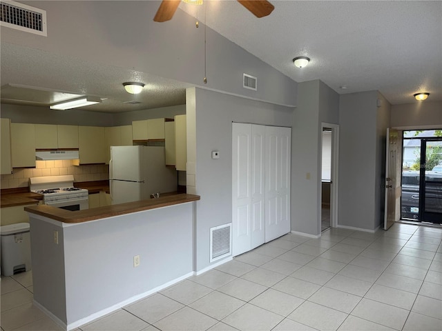 kitchen with under cabinet range hood, visible vents, and white appliances