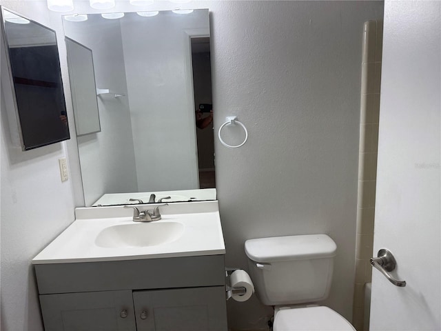 bathroom featuring toilet and vanity