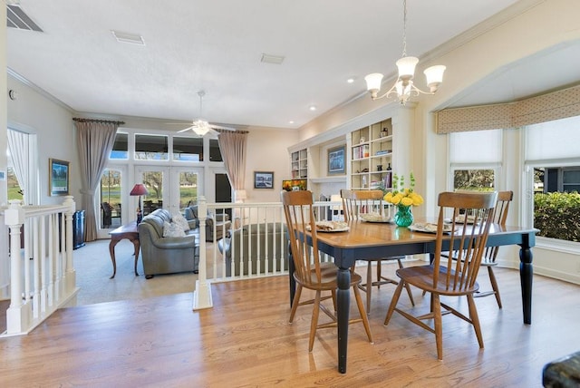 dining room with plenty of natural light, ornamental molding, and french doors