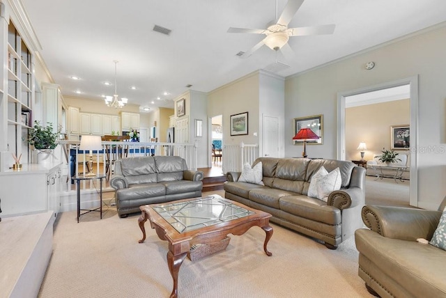 living room with light colored carpet, ornamental molding, and ceiling fan with notable chandelier