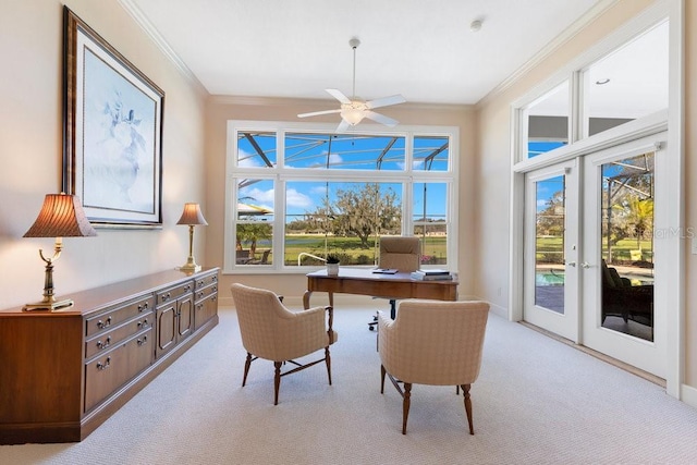 office space featuring ceiling fan, light colored carpet, crown molding, and french doors