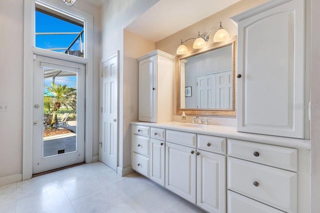 bathroom featuring a high ceiling, plenty of natural light, and vanity