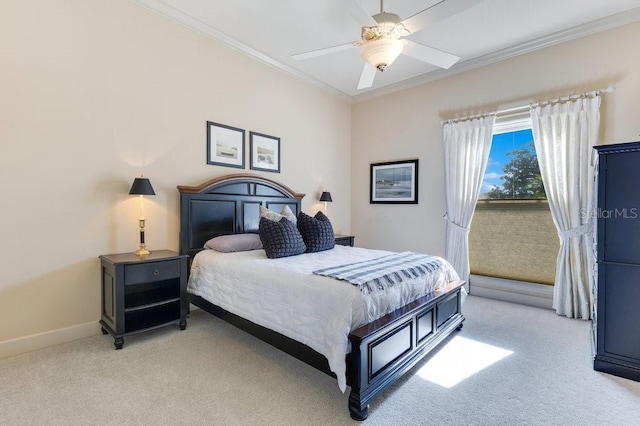 carpeted bedroom with ceiling fan and ornamental molding