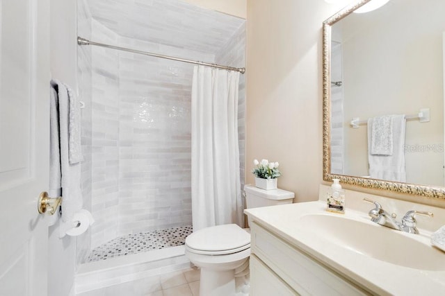 bathroom featuring tile patterned floors, toilet, vanity, and a shower with curtain