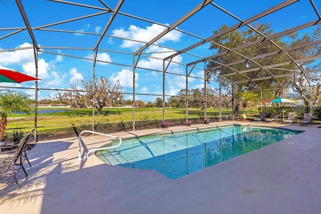 view of swimming pool with glass enclosure and a patio