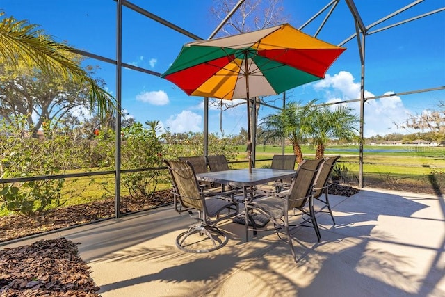 view of patio featuring a lanai and a water view