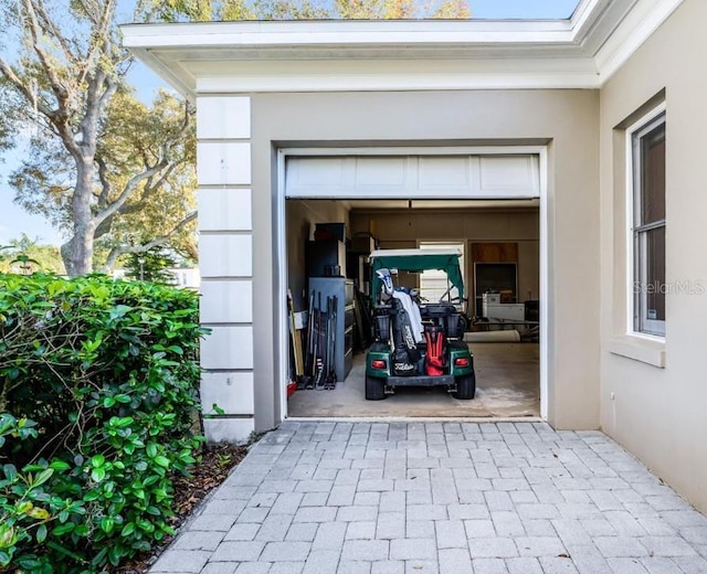 garage with decorative driveway