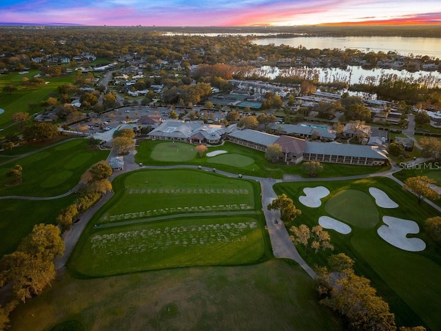 drone / aerial view with a water view and view of golf course