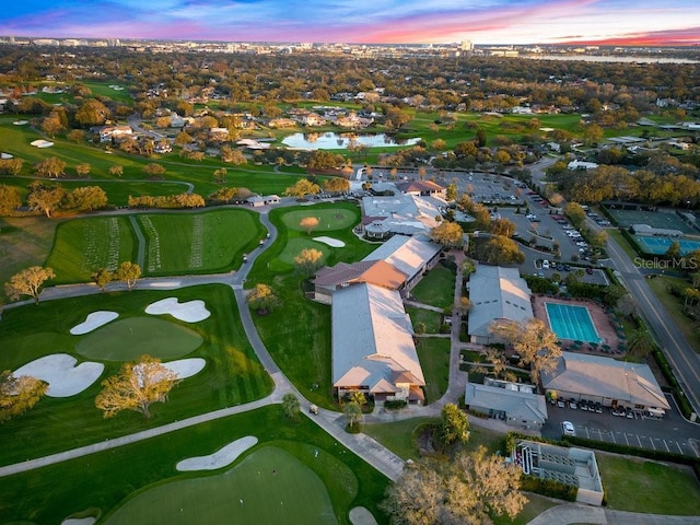 birds eye view of property with a water view and golf course view