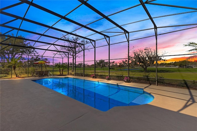 outdoor pool with a lanai and a patio area