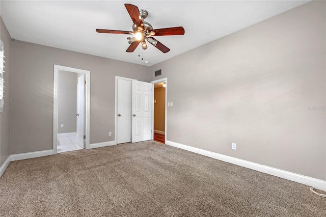 unfurnished bedroom with carpet floors and ceiling fan