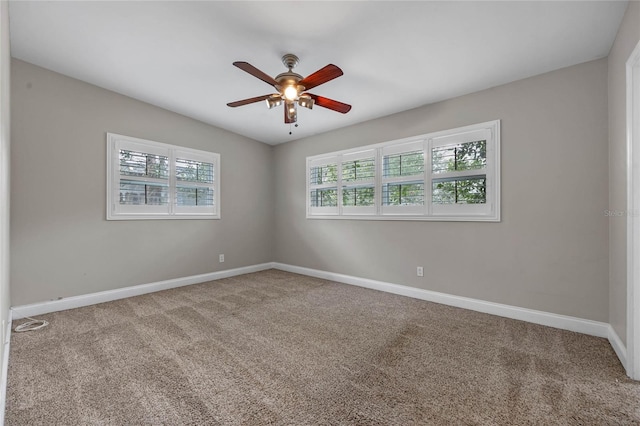 empty room featuring ceiling fan and carpet