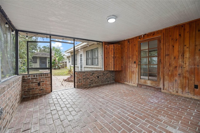 unfurnished sunroom featuring wood ceiling