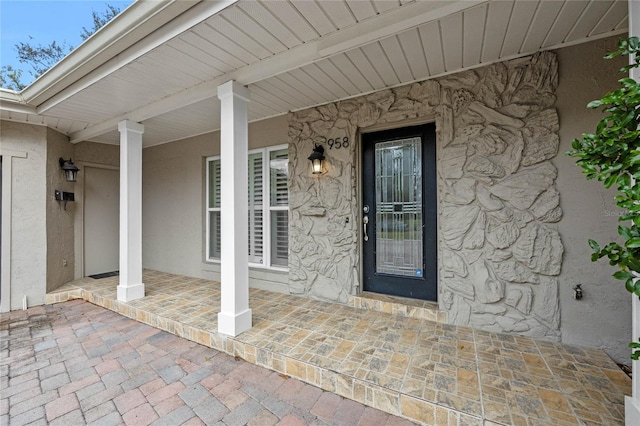 view of exterior entry with covered porch