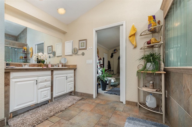 bathroom featuring vanity and vaulted ceiling