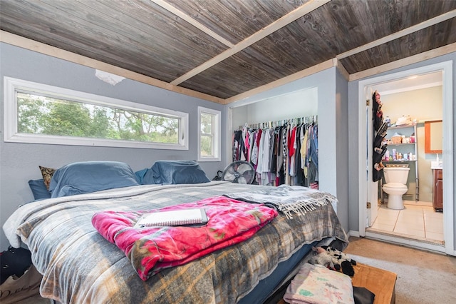 bedroom featuring wooden ceiling, ensuite bathroom, and a closet