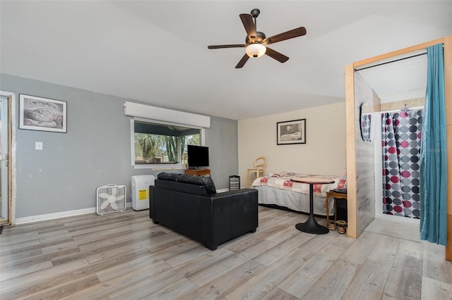 living room featuring ceiling fan and light wood-type flooring