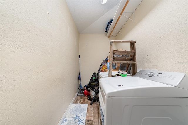 clothes washing area with a textured ceiling, hardwood / wood-style flooring, and washer / clothes dryer