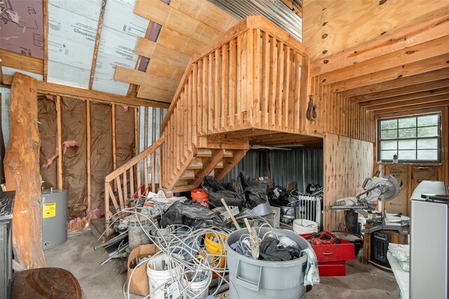 misc room with concrete floors and water heater