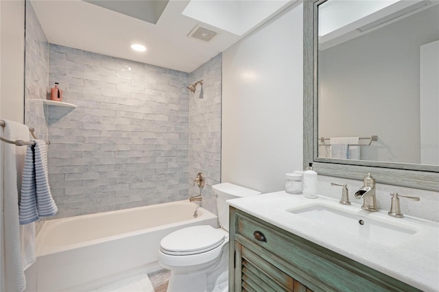 full bathroom featuring vanity, toilet, and tiled shower / bath