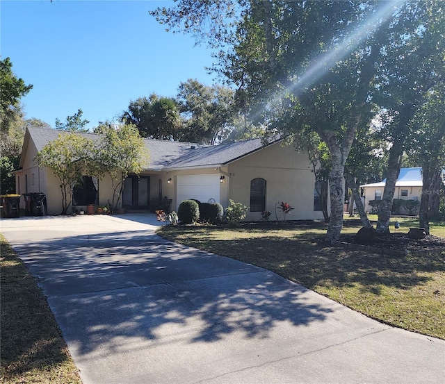 single story home with a garage and a front yard