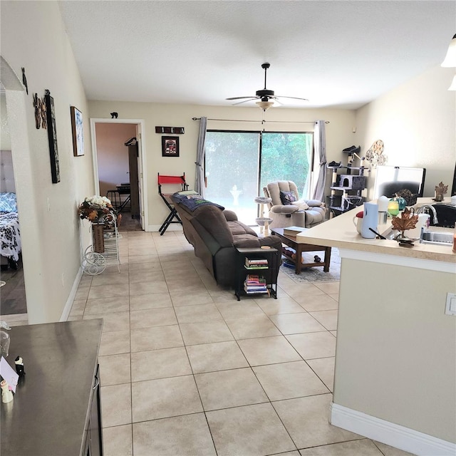 living room featuring light tile patterned flooring and ceiling fan