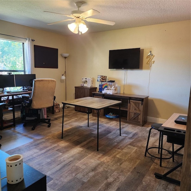 office area featuring a textured ceiling, dark hardwood / wood-style floors, and ceiling fan