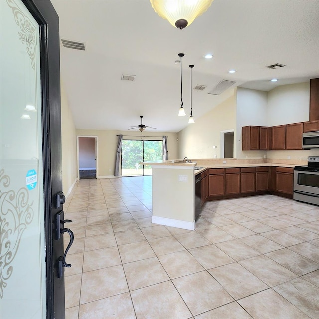 kitchen featuring stainless steel appliances, vaulted ceiling, sink, and light tile patterned floors