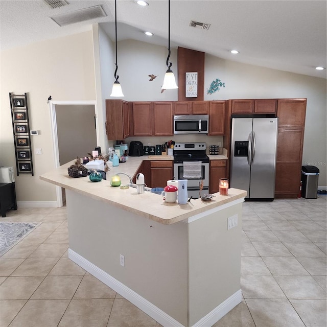 kitchen with lofted ceiling, hanging light fixtures, light tile patterned floors, and appliances with stainless steel finishes