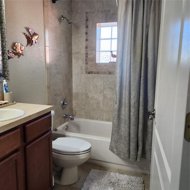 full bathroom featuring vanity, shower / bath combination with curtain, tile patterned floors, and toilet