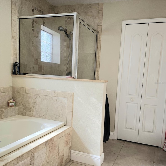 bathroom featuring tile patterned floors and separate shower and tub