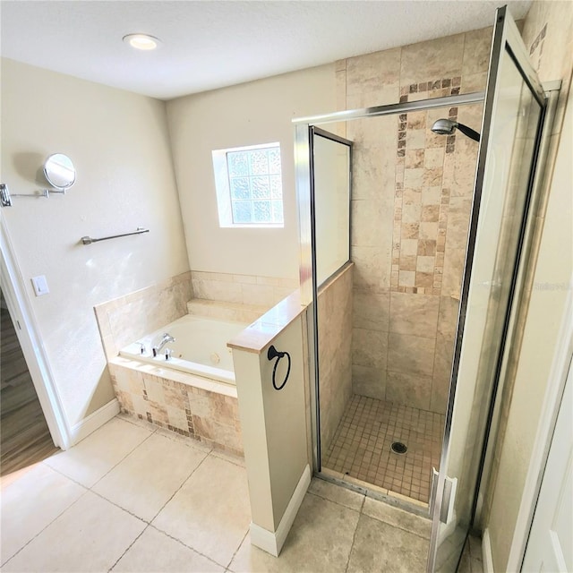 bathroom featuring tile patterned floors and shower with separate bathtub